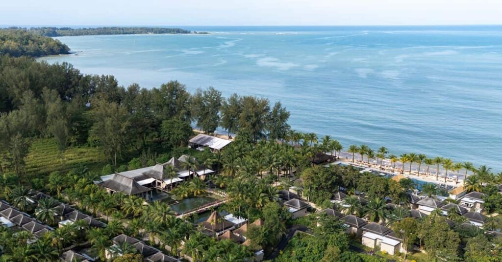 Aerial view of Ananea Beyond Khaolak, a beachfront resort on Pak Weep Beach in Khao Lak, featuring tropical gardens, private villas, a swimming pool, and the Andaman Sea.